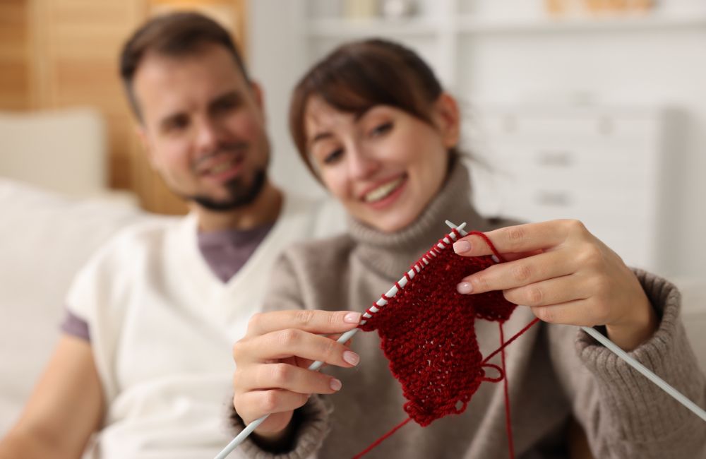 An image of a woman learning how to knit.