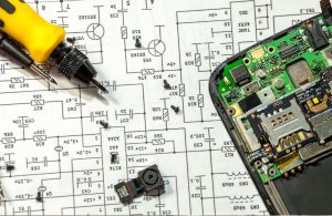 An image of a soldering iron and speaker board for an article about speaker repair work.