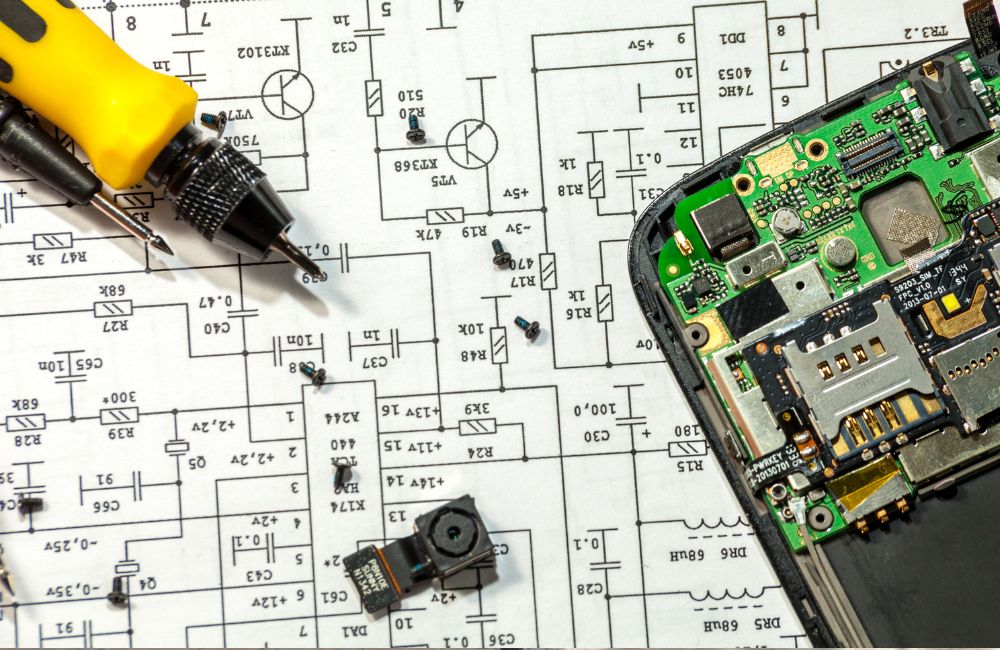 An image of a soldering iron and speaker board for an article about speaker repair work.