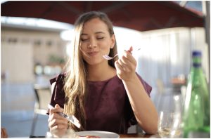 A woman enjoying the Most Popular Cooking Style and Dishes