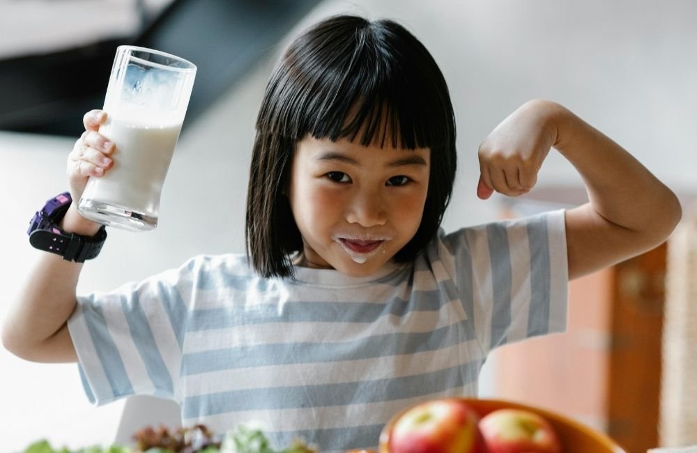 An image of a school child drinking milk.