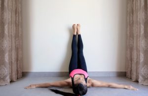 An image of a remote employee doing wall pilates.