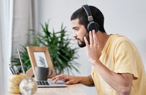 An image of a remote worker using noise cancelling headphones.