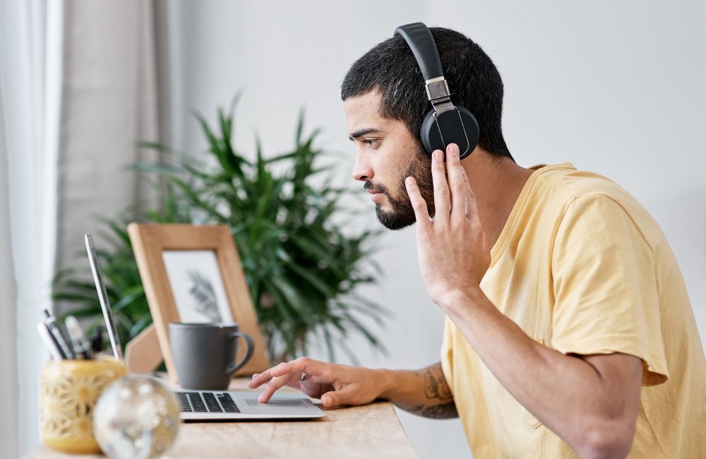 An image of a remote worker using noise cancelling headphones.