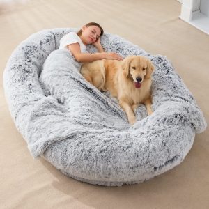 An image of an owners and her pet on one of many human dog beds.