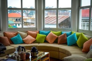 An image of indoor decoration done through the mix and match pillows on the sofa.