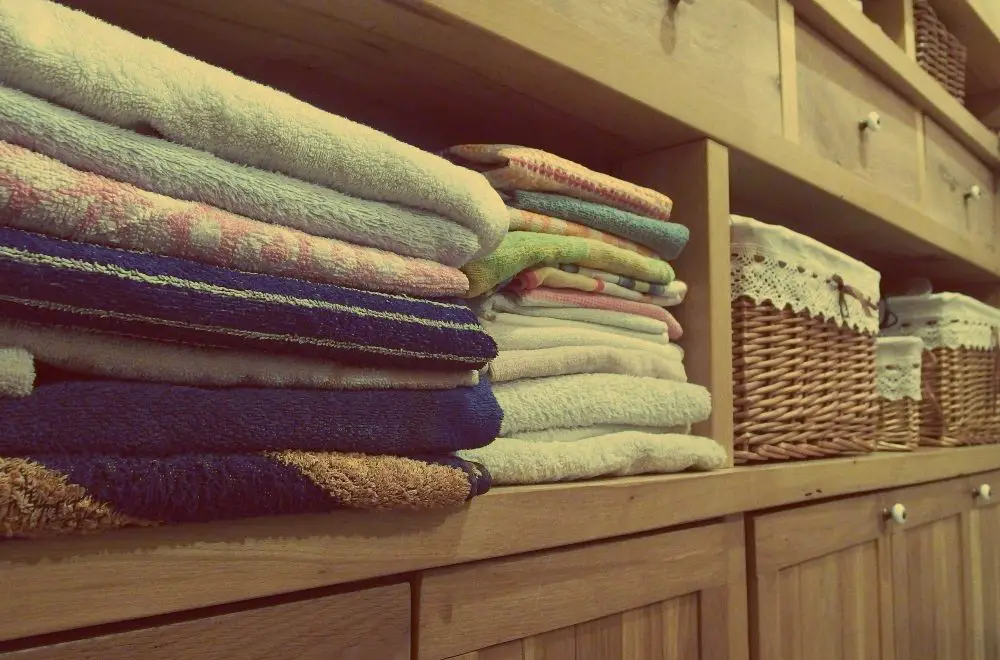 An image of towels and hampers arranged in shelves. 