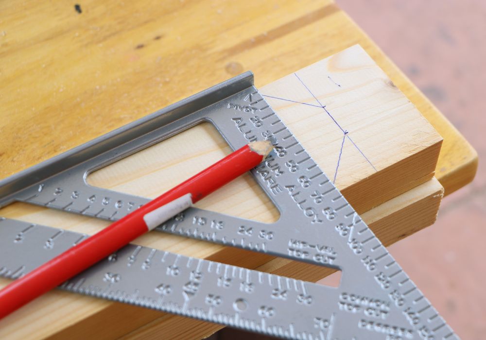 An image of a speed square and pencil. 