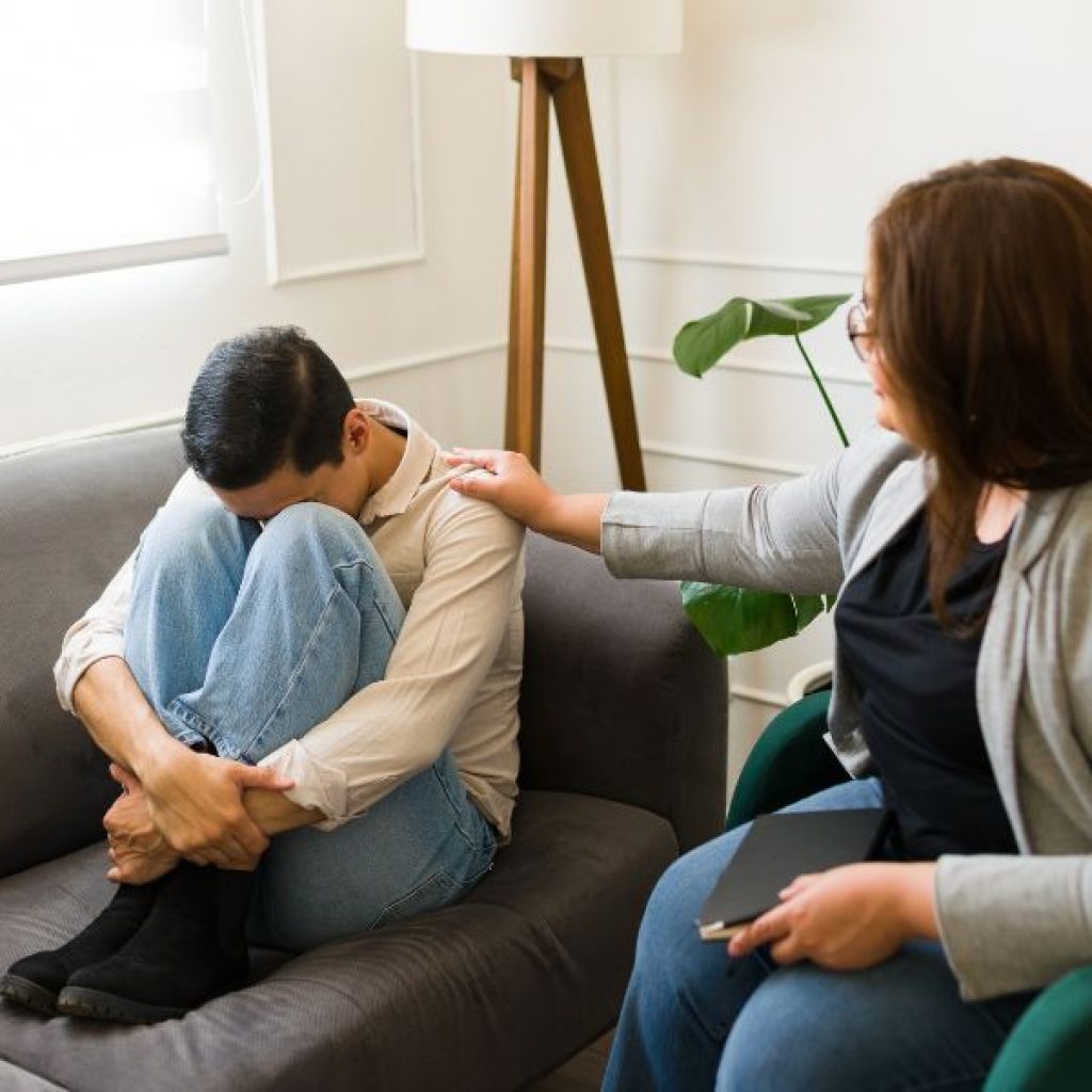 An image of a Gen Z man being consoled. 