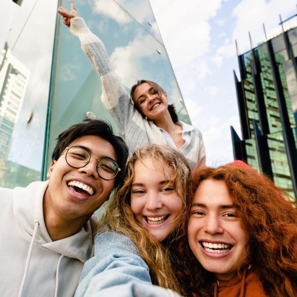 A group of Gen Z adults posing for a picture. 