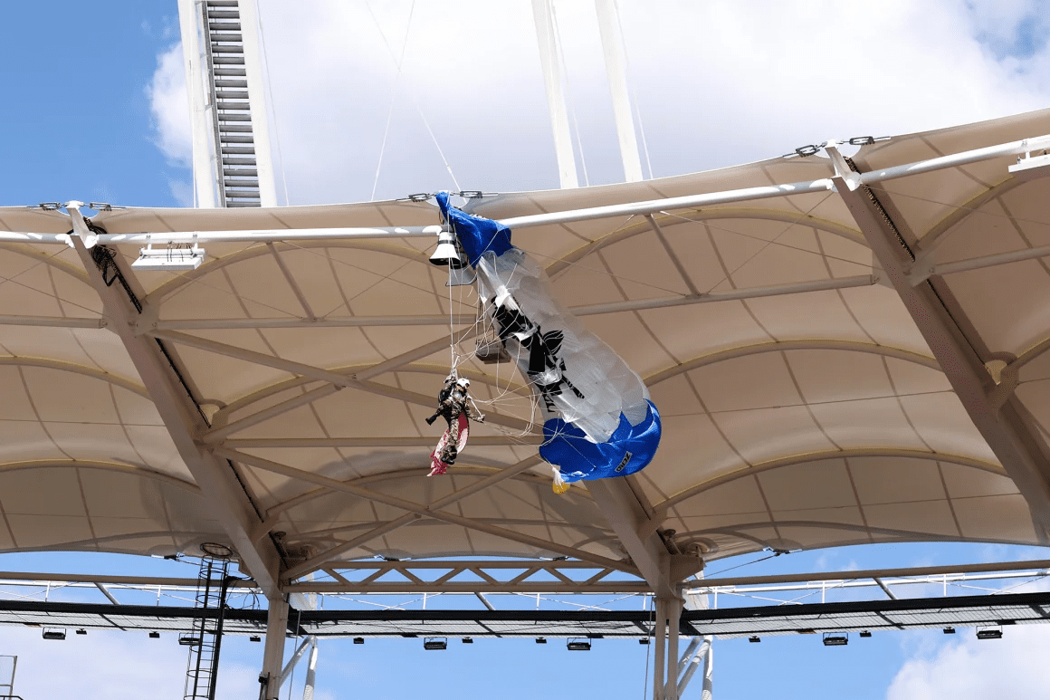 An image of a parachutist dangling from building. 