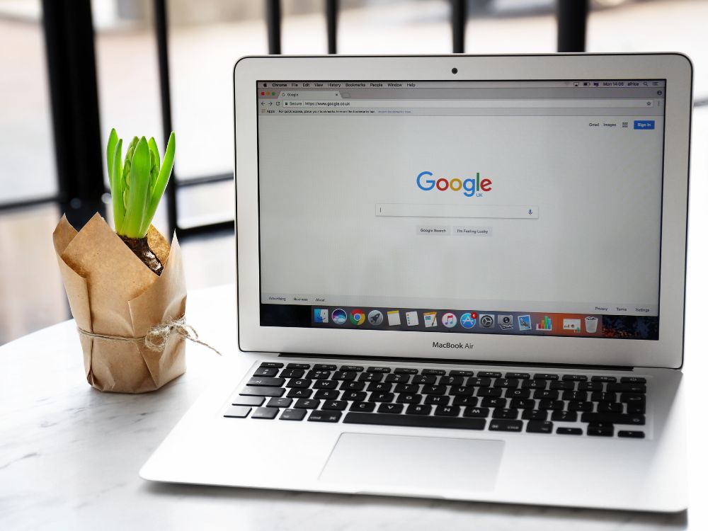 An image of a laptop with the browser showing Google's search page.