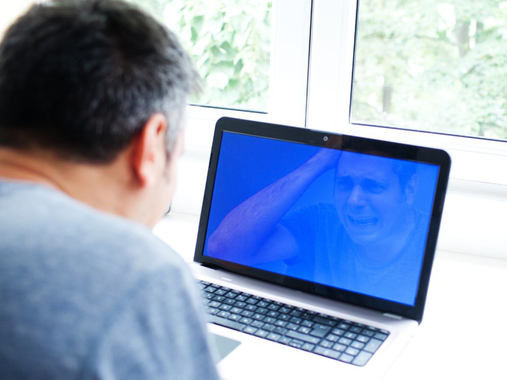 An image of a person experiencing the Blue Screen of Death.