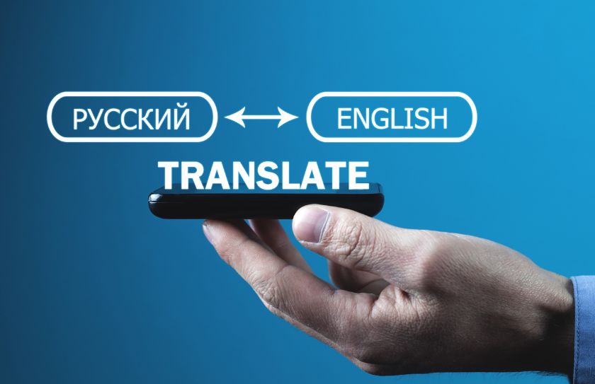 An image of a person using a phone to translate Russia to English. 