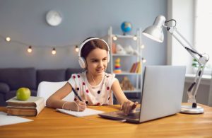An image of a kid doing her homework for an article about homework stations.