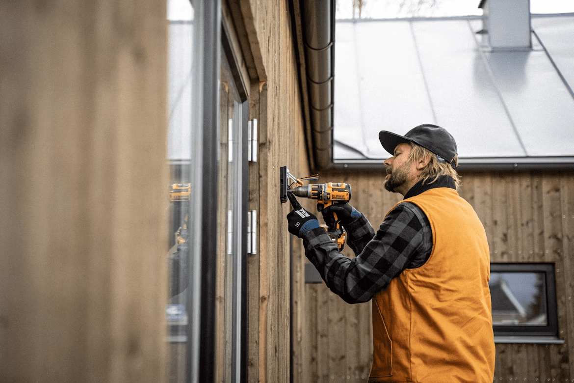 An image of a contractor installing a smart door lock.