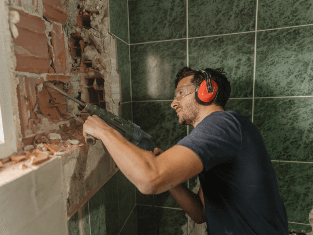 A builder renovating a bathroom