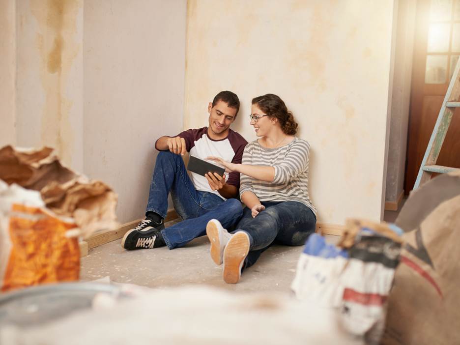 A couple searching home listings in Canada